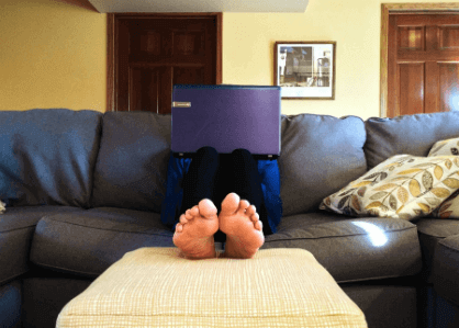 coder sitting with laptop on their couch